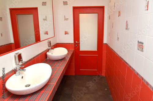 The washing room in a bathroom in red tones. Stylization under t