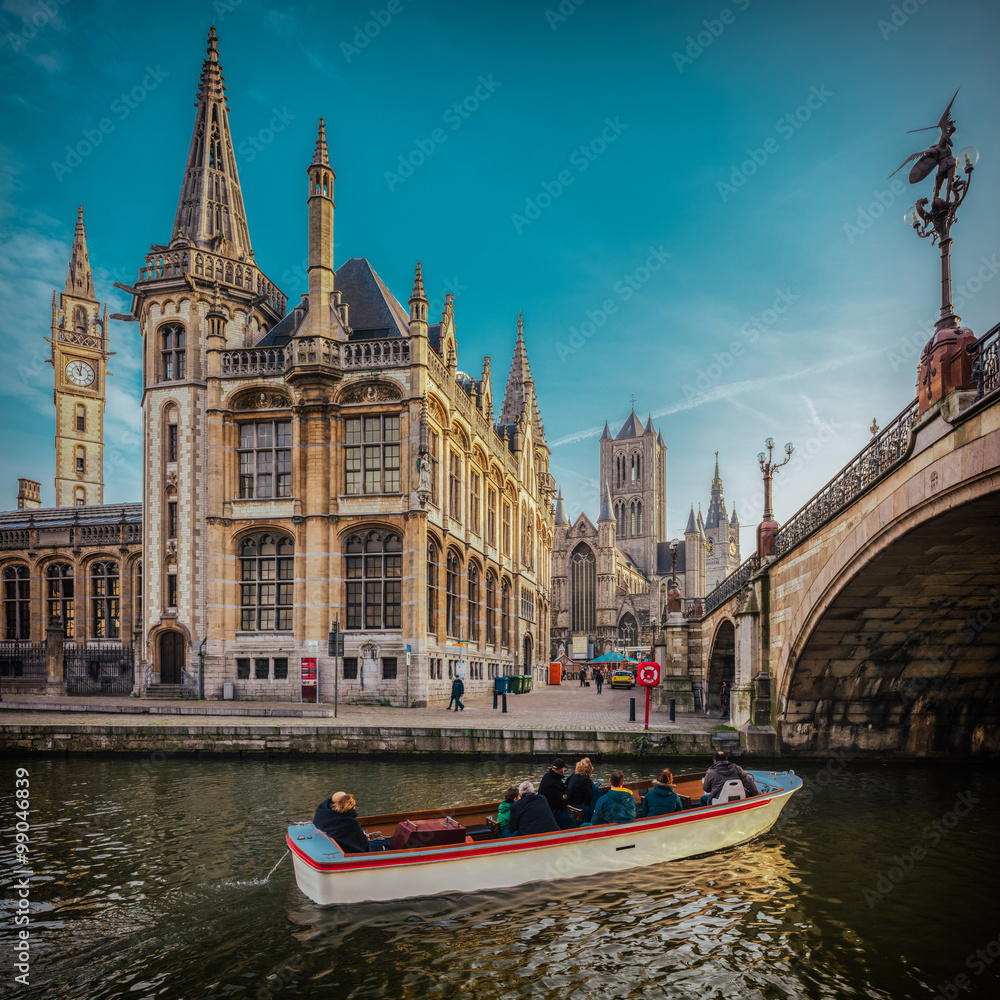 View over the Ghent, Belgium, as seen from the touristic boat, with a film warm colors emulation and high resolution, large panorama for huge prints