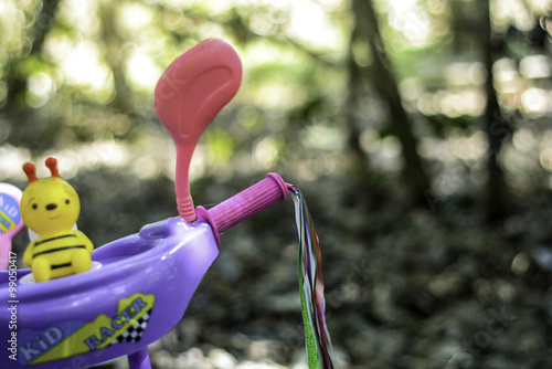 a toddler tricyle with squakey toy on blurred background. image contained small depth of field photo