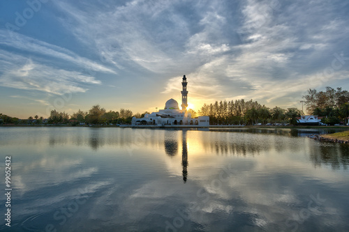 Perfect reflection of a floating mosque Masjid Tengku Tengah Zaharah in Kuala Ibai, Terengganu, Malaysia during sunset photo