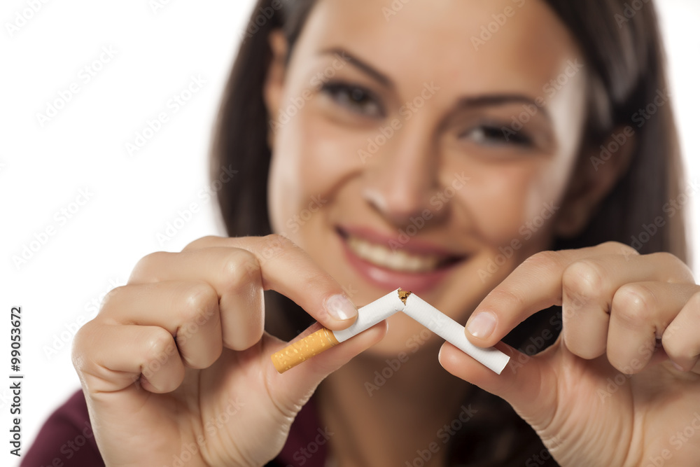 happy young woman breaking a cigarette happy young woman breaking a cigarette