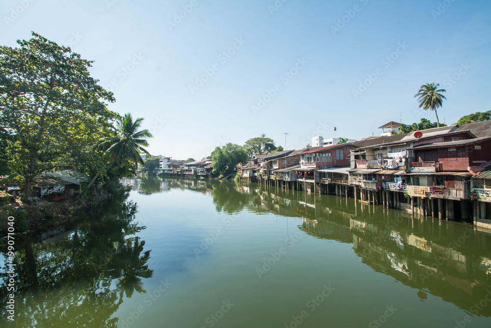 village near river in morning with clear blue sky at chantaboon village in chantaburi , Thailand