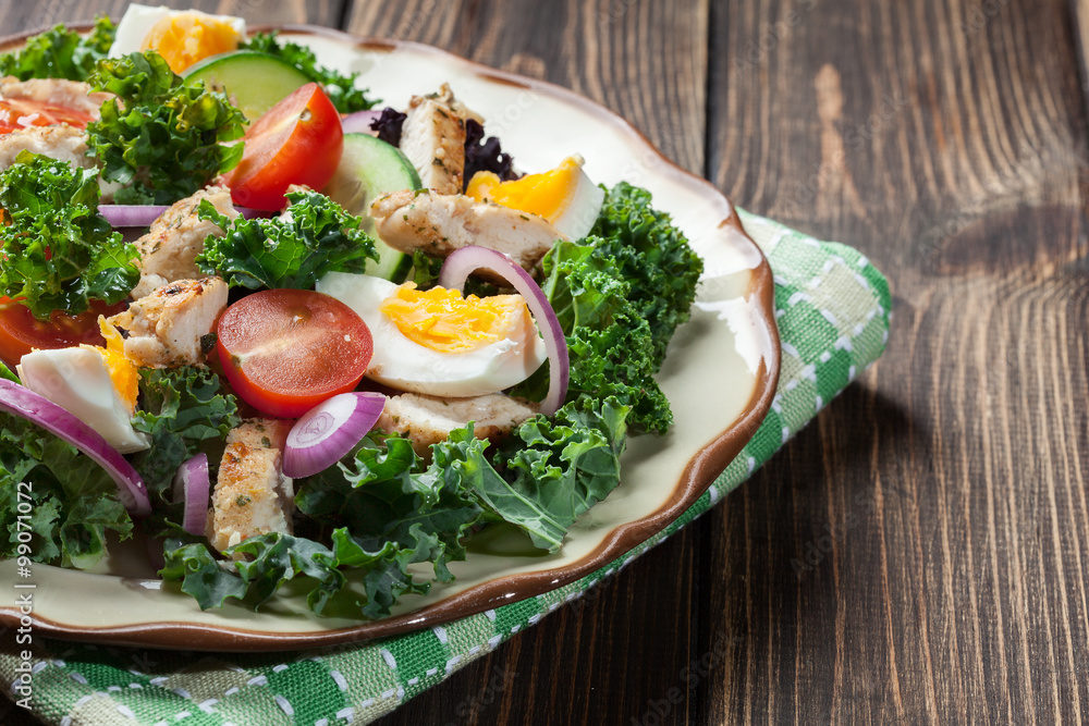Fresh salad with chicken, tomatoes, eggs and lettuce on plate Fresh salad with chicken, tomatoes, eggs and lettuce on plate