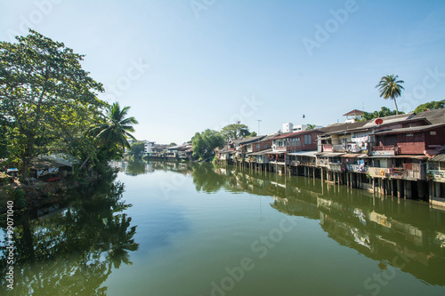 village near river in morning with clear blue sky at chantaboon village in chantaburi , Thailand