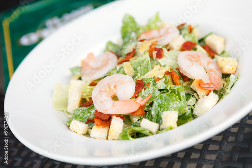 Caesar salad with shrimp and fresh vegetables. italian food.