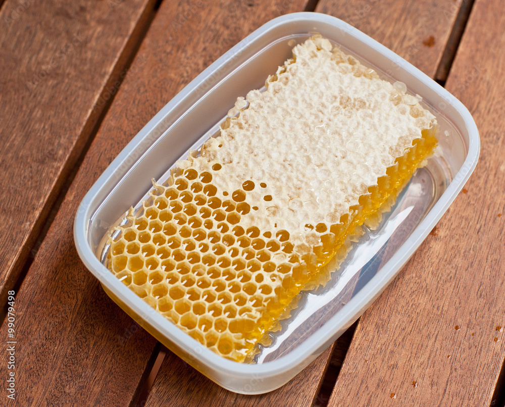 Honey from the hive on a wooden table
Honey from the hive on a wooden table