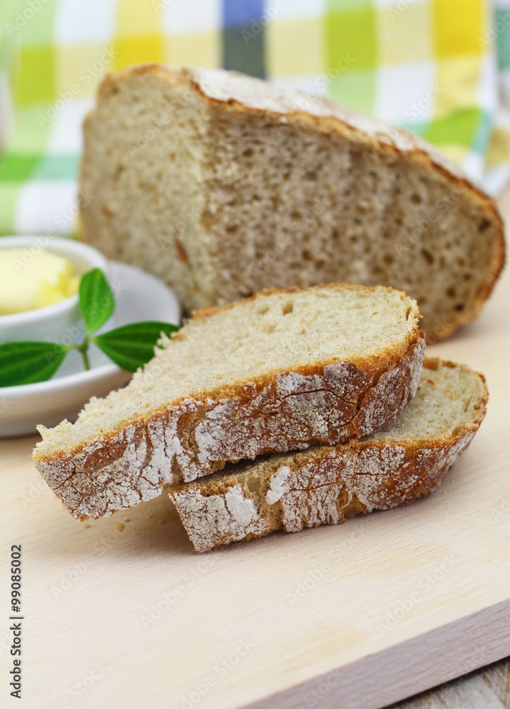 Slices of traditional rustic rye bread on wooden board
Slices of traditional rustic rye bread on wooden board