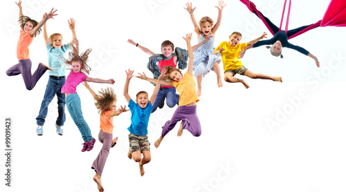 group of happy cheerful sportive children jumping and dancing