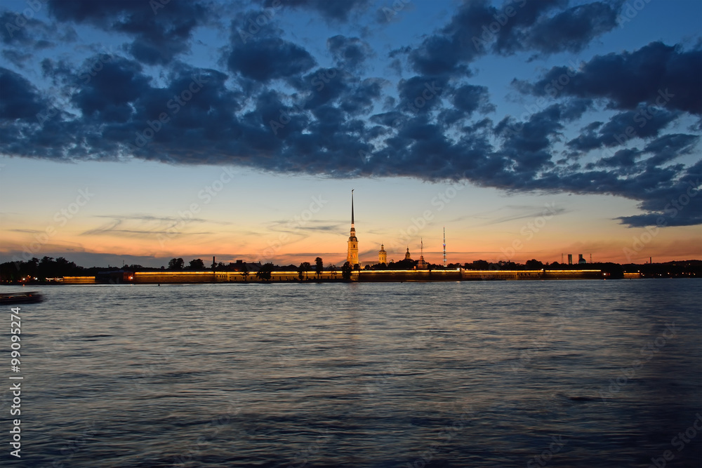 Peter and Paul fortress illuminated at sunset, the reflection Peter and Paul fortress illuminated at sunset, the reflection