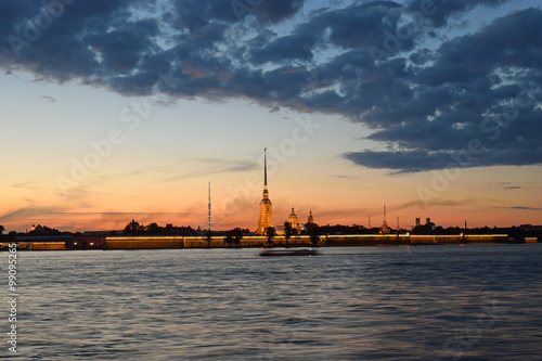 Peter and Paul fortress illuminated at sunset, the reflection 
