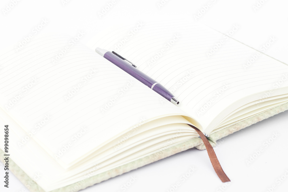 Notebook with pen isolated on white background Notebook with pen isolated on white background