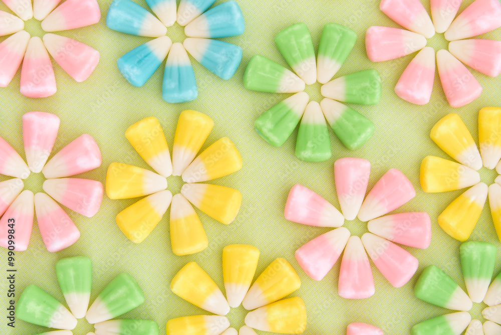 Close up of festive Easter candy corn in flower patterns on a light green background
Close up of festive Easter candy corn in flower patterns on a light green background