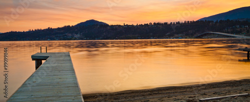 Scenic Mountain Sunrise and Jetty on Still Lake
