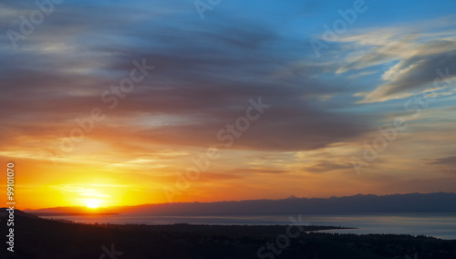 Sunset over Issyk Kul lake  at a hazy evening