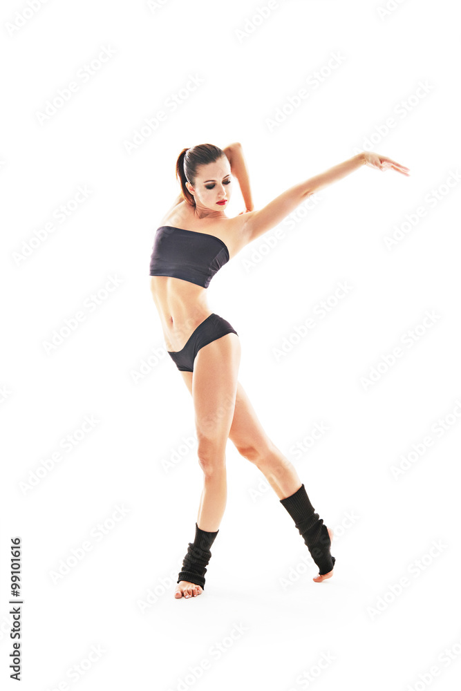 Young beautiful ballet dancer posing on a studio