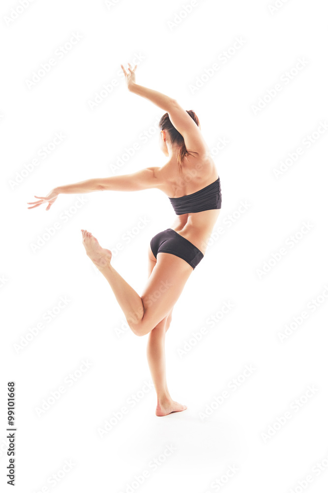 Young beautiful ballet dancer posing on a studio