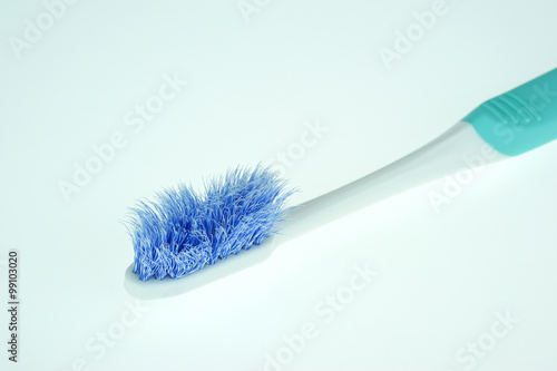 Old toothbrush close-up on white background