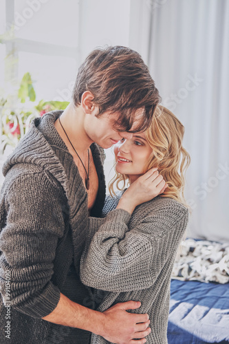 attractive man and woman in the bedroom together cuddling cute