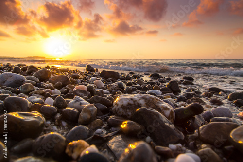 A beautiful beach on a Greek island in summer, under warm evening light © Calin Tatu