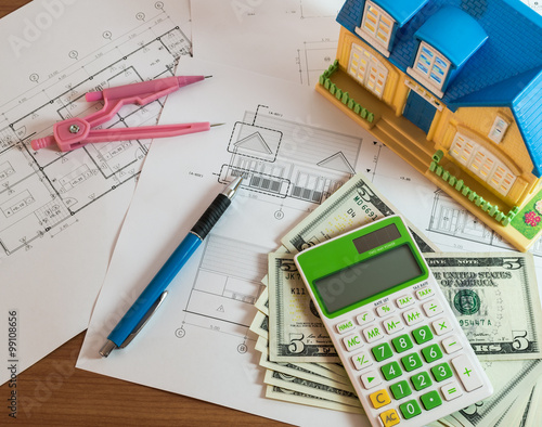 Modelhouse, calculator and US Dollars on construction planning