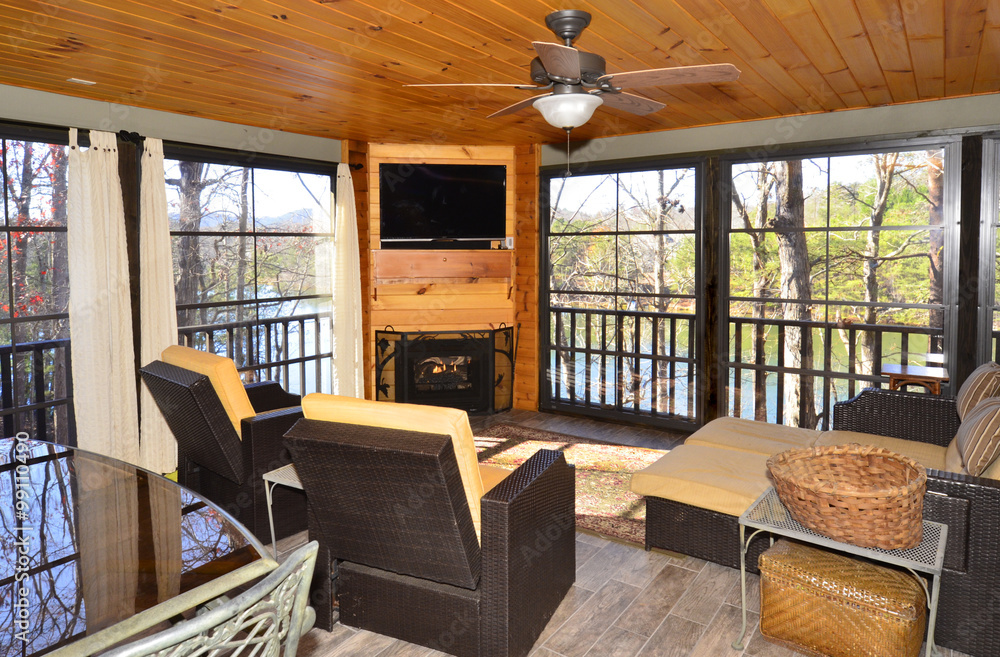 An enclosed porch area on a house overlooking a lake. An enclosed porch area on a house overlooking a lake.