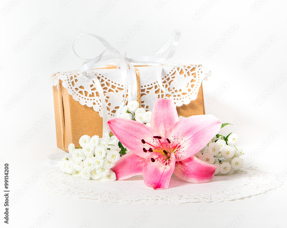 Fresh pink lily flower and gift box as a present for a holiday. Fresh pink lily flower and gift box as a present for a holiday.