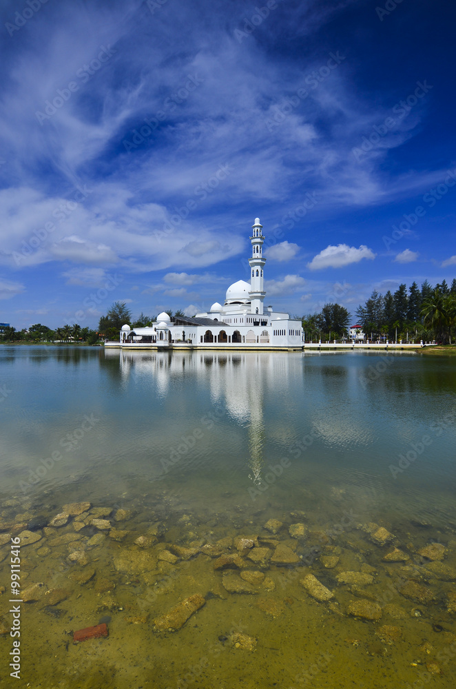 Beautiful white mosque with reflection in the lake during clean