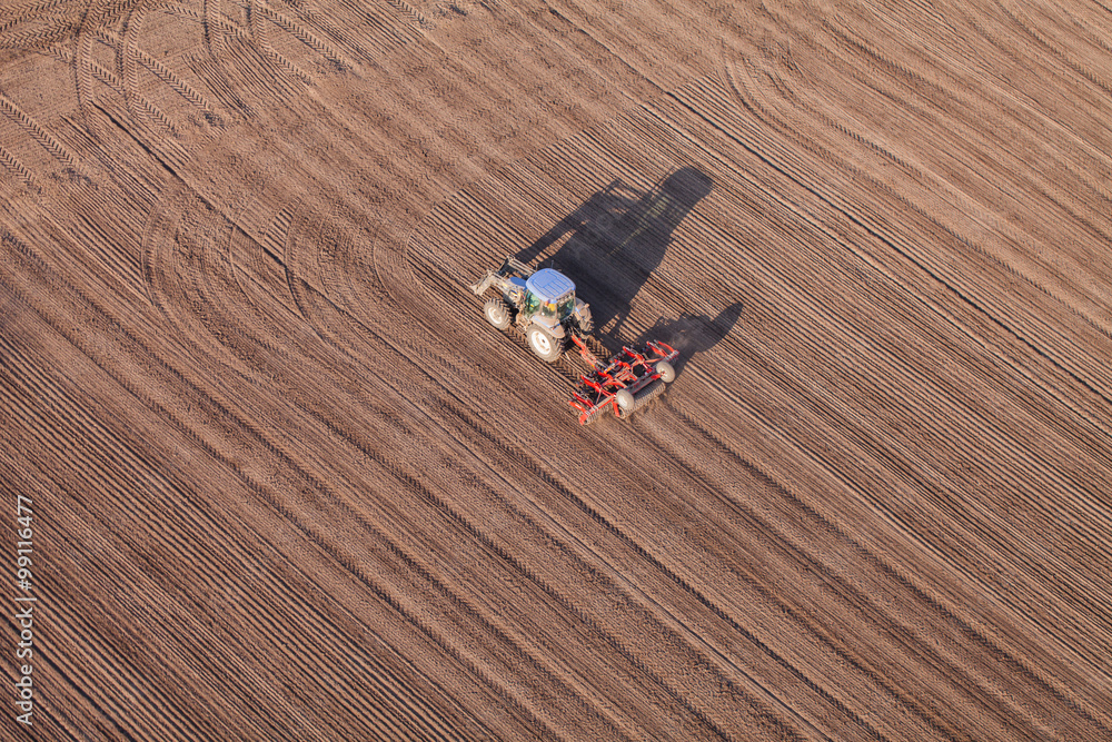 aerial view of harvest fields with tractor