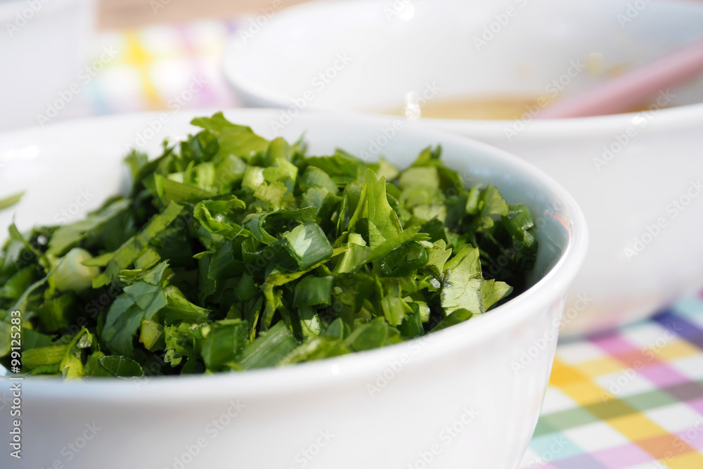 Celery Coriander Cilantro Green Onion sliced mixed in the white cup closeup Celery Coriander Cilantro Green Onion sliced mixed in the white cup closeup