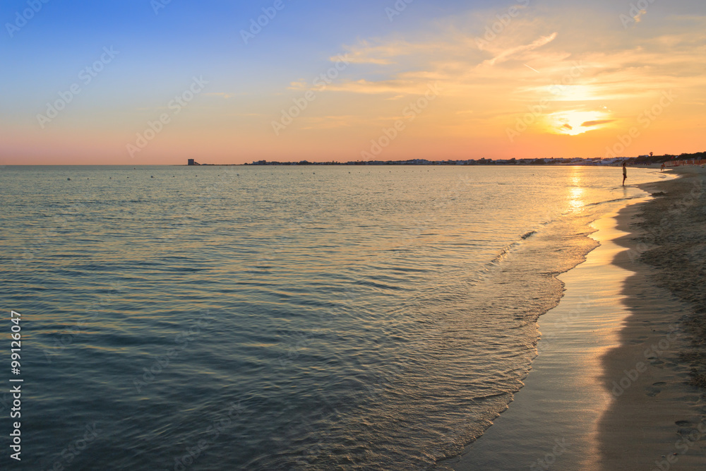 The most beautiful sandy beaches of Apulia.Salento coast: shoreline at sunset.Porto Cesareo skyline.ITALY (Lecce) The sandy coastline is characterized by dunes covered with Mediterranean scrub.