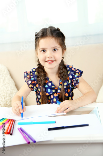 Cute little girl drawing pi...