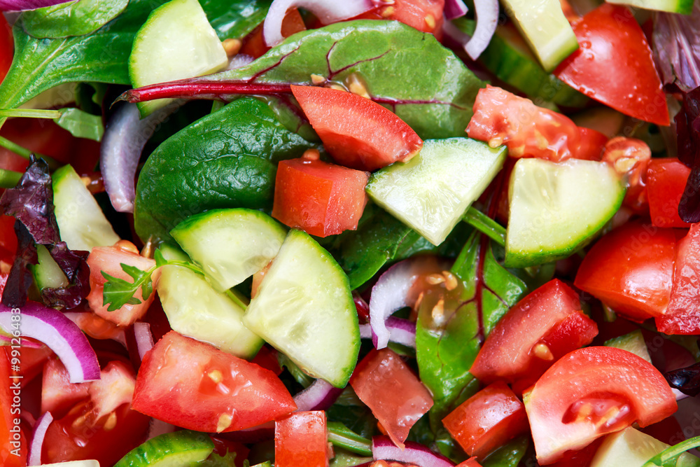 fresh raw vegetable mixed salad. close up, view from top fresh raw vegetable mixed salad. close up, view from top
