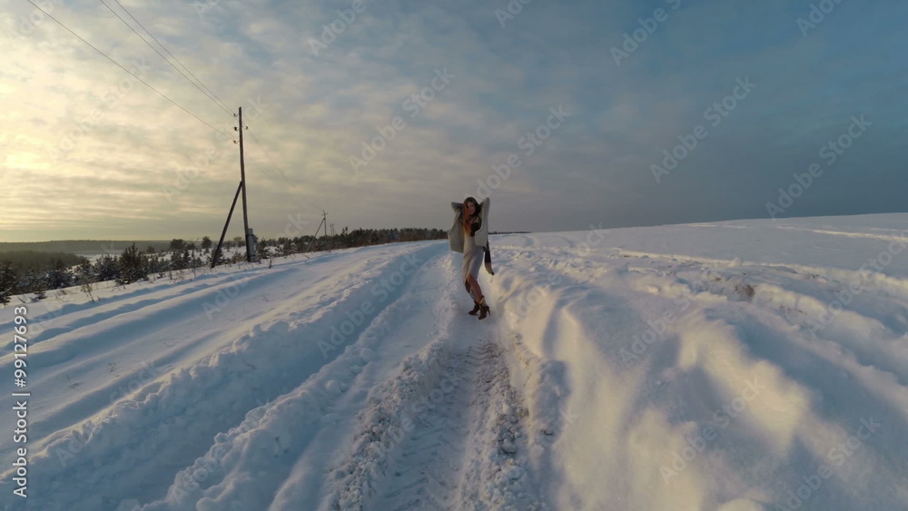 girl is running through the snow at cold winter girl is running through the snow at cold winter