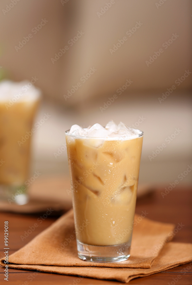 Cups of ice coffee on wooden table Cups of ice coffee on wooden table