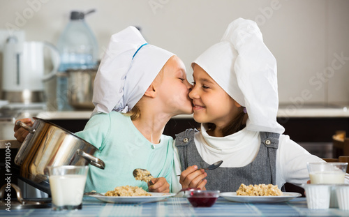 Small girls eating healthy oatmeal