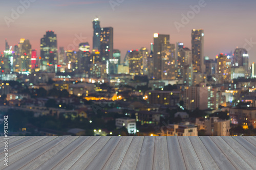 Opening wooden floor, Night view of blurred city lights © pranodhm
