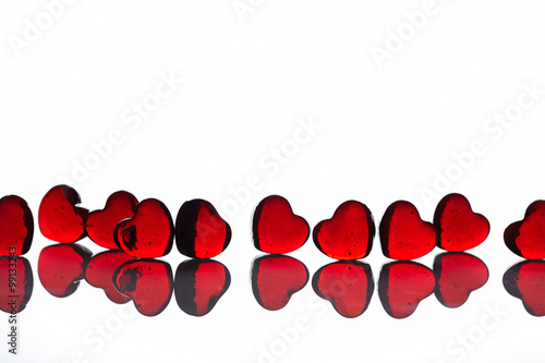 red glass hearts on white background