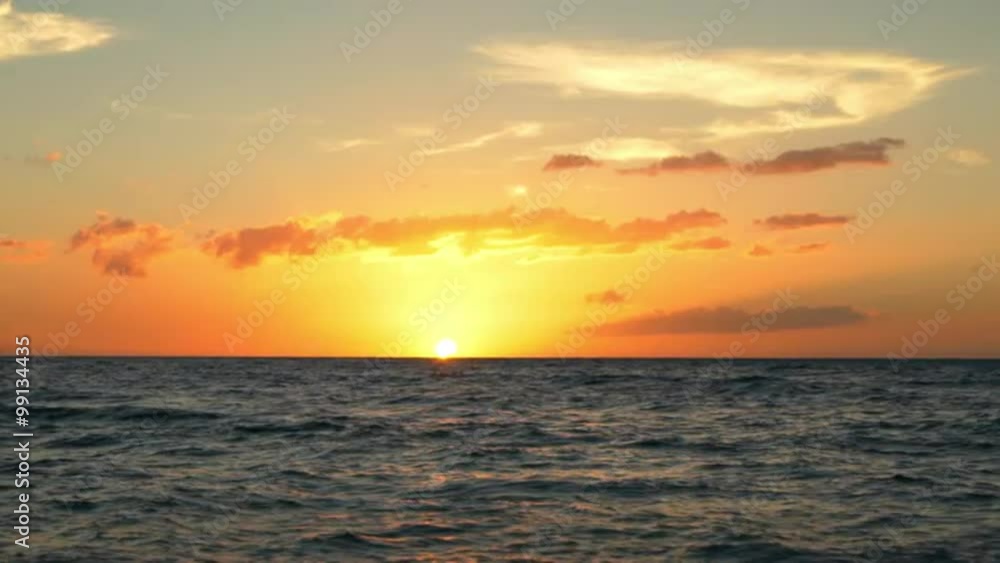 Amazing Sunset Over Tropical Beach. Waves Roll up White Sand in SLOW MOTION. Luxury Resort Vacation Amazing Sunset Over Tropical Beach. Waves Roll up White Sand in SLOW MOTION. Luxury Resort Vacation