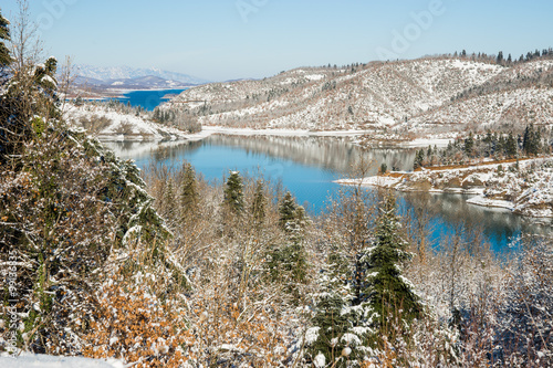 Winter landscape with lake Plastira and snow in the mountains photo