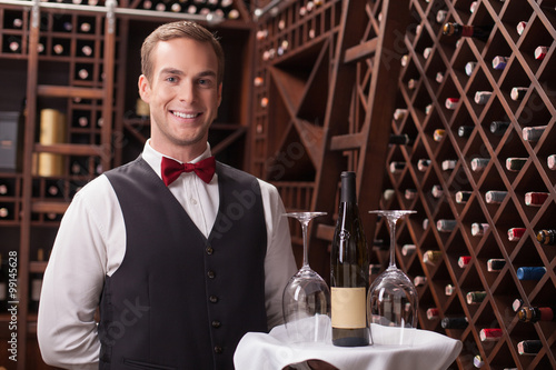 Vászonkép Attractive young sommelier is working in restaurant