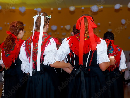 young dancing women in traditional folk dress on wedding feast ceremony. photo