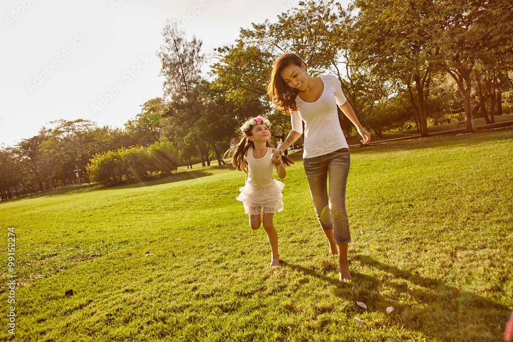 Fototapeta premium Lifestyle portrait mom and daughter in happines at the outside in the meadow
