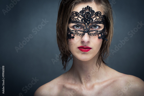 Attractive young woman with mask (color toned image)