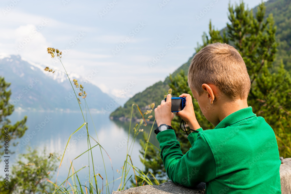 Boy taking picture with digital compact camera Boy taking picture with digital compact camera