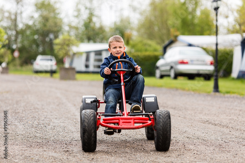 Boy driving on buggy cart