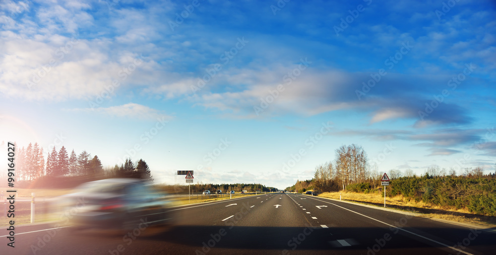 Blurred car on motorway road in early morning Blurred car on motorway road in early morning