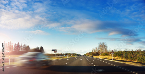 Blurred car on motorway road in early morning