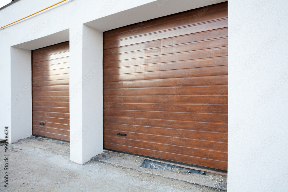 Naklejka premium Double brown garage door in a new house