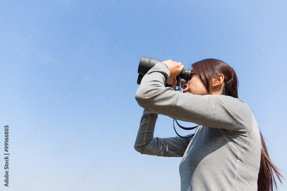 Asian Young woman use of the binoculars with clear blue sky Asian Young woman use of the binoculars with clear blue sky
