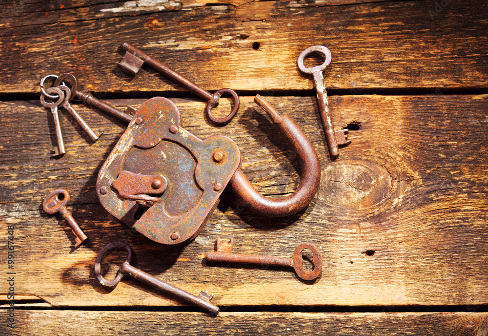 old lock and keys on wooden table old lock and keys on wooden table